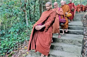  ?? ?? In step with sati: The reclusive monks of the forest monastery. Pix by M.A. Pushpa Kumara
