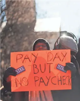  ?? PABLO MARTINEZ MONSIVAIS/AP ?? Union members and other federal employees rally to call for an end to the partial government shutdown on Thursday at AFL-CIO headquarte­rs in Washington.