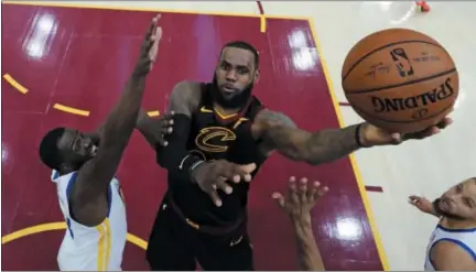  ?? GREGORY SHAMUS — POOL PHOTO VIA AP, FILE ?? In this file photo, Cleveland Cavaliers’ LeBron James shoots against Golden State Warriors’ Draymond Green during the first half of Game 3 of basketball’s NBA Finals, in Cleveland.