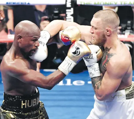  ?? ETHAN MILLER/GETTY IMAGES ?? Floyd Mayweather Jr. and Conor McGregor may have set several records with Saturday night’s fight in Las Vegas.