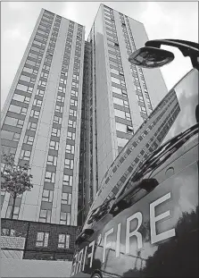  ?? [ALASTAIR GRANT/THE ASSOCIATED PRESS] ?? A fire engine is parked outside Burnham block in Camden, a borough in north London, on Saturday. The local council evacuated about 650 apartments in four buildings deemed unsafe because of fire hazards that include flammable external cladding.