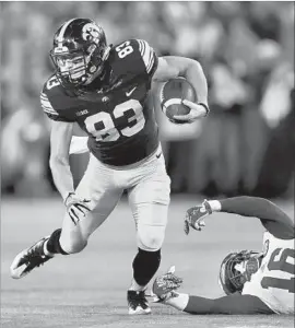  ?? Charlie Neibergall Associated Press ?? IOWA’S Riley McCarron, who had a 77-yard touchdown reception in the first quarter, breaks away from Nebraska safety Antonio Reed.