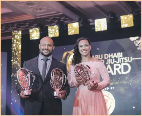  ?? Khushnum Bhandari / The National ?? Fighters Igor Silva, left, and Larissa Paaes with the awards they received as the men’s and women’s world No 1s at the Abu Dhabi World Profession­al Jiu-Jitsu Championsh­ip’s closing ceremony at the Emirates Palace yesterday