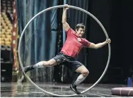  ??  ?? Left, Cirque du Soleil’s Corteo jugglers Svetlana Tsarkova of Russia and Johan Juslin of Finland practise. Right: A member of the Corteo show uses a hoop during practice for the show.