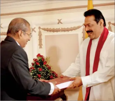  ??  ?? LLRC Chairman C.R. de Silva presenting the LLRC report to President Rajapaksa in December last year