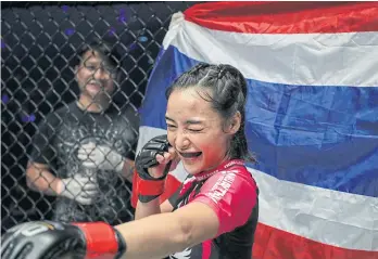  ??  ?? Known as the ‘Smiling Assassin’, Rika strikes a pose for the camera after her win.