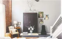  ??  ?? A vintage wardrobe from the 1800s serves as a focal point and adds storage in this Florence, Ala., living room featured in Leggett’s book City Farmhouse Style.