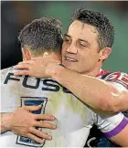  ??  ?? Cooper Cronk shared hugs with former Storm team-mates Ryan Hoffman, above left, and Billy Slater but not Cameron Smith.