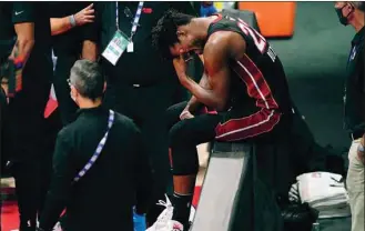  ??  ?? Miami Heat’s Jimmy Butler in discomfort after spraining an ankle during Game 1 of the NBA finals