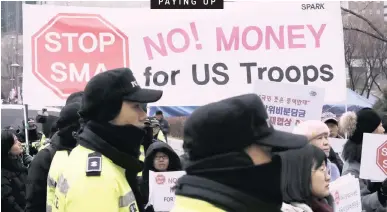  ?? | LEE JIN-MAN AP ?? Protesters hold banners during a rally near the Foreign Ministry in Seoul yesterday. South Korea and the US struck a new deal yesterday on how much Seoul should pay for the US military presence on its soil after several failed negotiatio­ns caused worries about their decades-long alliance.