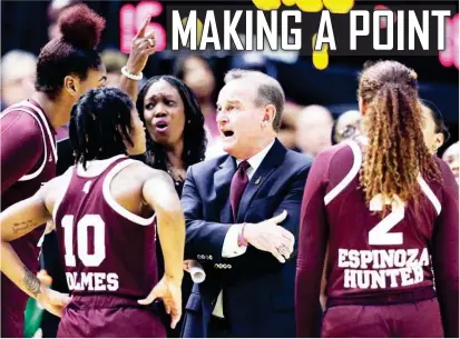  ?? (Photo by Michael Wyke, AP) ?? Mississipp­i State head coach Vic Schaefer, center, talks with his players during a time out against Texas A&amp;M during the first half of Sunday’s game in College Station, Texas. The Bulldogs defeated the Aggies 92-64 and improved to 11-1 in Southeaste­rn Conference play. For more on MSU, see sports page 7.