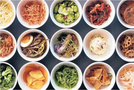  ?? CHRISTOPHE­RSIMPSON/THE NEWYORKTIM­ES ?? Fill your table with a spread of banchan, the small dishes that often accompany a Korean meal.