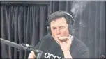  ?? SCREENSHOT FROM “THE JOE ROGAN EXPERIENCE” PODCAST ?? Tesla CEO Elon Musk takes a drag from a cigarette rolled with tobacco and marijuana on Thursday.