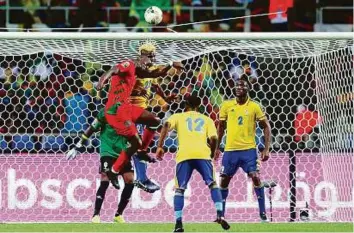  ?? Reuters ?? Guinea-Bissau’s Nanissio Justino Mendes Soares competes in the air with Gabon’s Didier Ibrahim Ndong in an African Cup of Nations match in Gabon on Saturday.