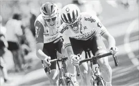  ?? THIBAULT CAMUS THE ASSOCIATED PRESS ?? South Africa’s Daryl Impey, right, and Belgium’s Tiesj Benoot go hard during the ninth stage of the Tour de France on Sunday. Impey won the stage.