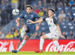  ??  ?? Brazilian striker Diogo Luis Santo, left, scored both goals for Buriram United.