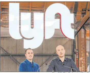  ?? Ringo H.W. Chiu The Associated Press file ?? Lyft co-founders John Zimmer, left, and Logan Green speak before they ring a ceremonial opening bell in Los Angeles in 2019.