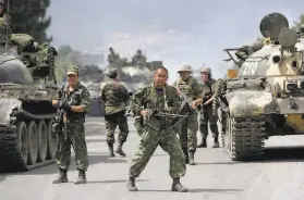  ?? Darko Bandic / Associated Press 2008 ?? Russian soldiers block a road near Gori, northwest of the Georgian capital of Tbilisi, in 2008, when troops routed the Georgian military in a fiveday war.