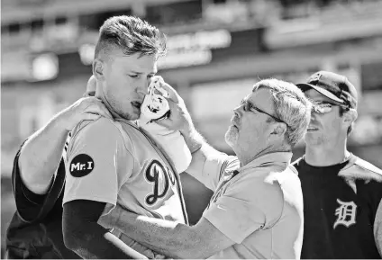  ?? JESSE JOHNSON, USA TODAY SPORTS ?? Trainers tend to Tigers outfielder JaCoby Jones after he was hit in the mouth by a pitch from Twins reliever Justin Haley on April 22. Jones was placed on the disabled list.