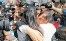  ??  ?? Kang Ying hugs her mother, Liu Chengying, during their reunion in Chengdu.