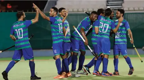  ??  ?? Ahli-Sidab players celebrate their win over Seeb in the first semifinal of the 50th His Majesty’s Cup Hockey Championsh­ip at the Sultan Qaboos Sports Complex on Sunday night