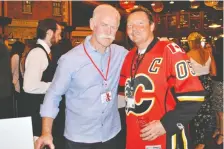  ??  ?? The tournament fundraised for Cerebral Palsy Kids and Families. From left, Flames icon Lanny Mcdonald and Frozen Memories’ Lee Ross.