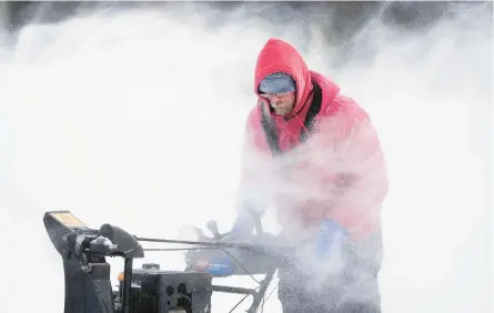  ?? CHARLIE NEIBERGALL/AP ?? Mark Sorter braves bone-chilling cold to clear snow from a skating rink Friday in Des Moines, Iowa.