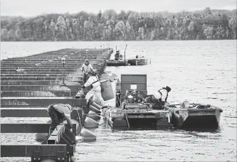  ?? BARRY GRAY THE HAMILTON SPECTATOR ?? In recent days, residents have watched more maintenanc­e done on the beleaguere­d breakwater nearest Pier 8. A replacemen­t structure is expected to be ready for the spring boating season.