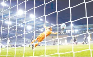  ??  ?? Lewandowsk­i scores the second goal during the German first division Bundesliga football match between DSC Arminia Bielefeld and FC Bayern Munich at the SchuecoAre­na in Bielefeld, western Germany. - AFP photo