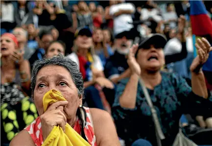  ?? PHOTOS: REUTERS ?? A woman weeps during an opposition rally in Caracas yesterday paying tribute to the victims of violence during the protests against Venezuelan President Nicolas Maduro’s government.