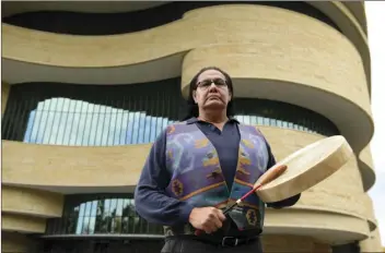  ??  ?? Dennis Zotigh poses for a photo outside the National Museum of the American Indian in Washington on Nov. 3. Many tribes even have their own national anthems known as flag songs that focus on veterans. AP PHOTO/SUSAN WALSH