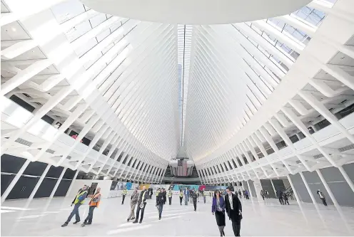  ?? AFP ?? People walk through the partially-opened World Trade Center Transporta­tion Hub in New York City on Thursday.