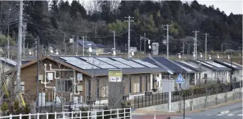  ??  ?? Solar panels are set up on the roofs of housing for disaster victims in Naraha.