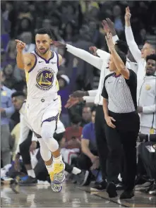  ?? Ben Margot ?? The Associated Press Warriors guard Stephen Curry celebrates a basket during the first half of a 108-100 win over the Thunder on Tuesday in Oakland, Calif.