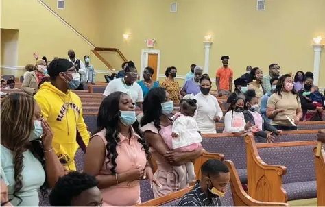  ?? (Special to the Commercial) ?? Apostle Christophe­r Mack of Highland Baptist Church in Pine Bluff (right) delivers a sermon to his congregati­on on Easter Sunday. On Easter last year, his pews were empty because of the covid-19 pandemic.