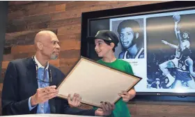  ?? RICK WOOD / MILWAUKEE JOURNAL SENTINEL ?? Beni Levin, 11, is all smiles after getting an autograph from NBA and Milwaukee Bucks legend Kareem Abdul-Jabbar. Abdul-Jabbar was made an appearance Thursday night at a event where the Bucks were hosting fans interested in buying suites for the new...