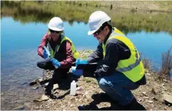  ??  ?? Sue Wilson of the University of New England, who studies mine contaminat­ion of the Macleay, collects water samples at Hillgrove Mine with Daniel Calderwood, the mine’s environmen­tal manager.