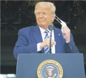  ?? (Photo: AFP) ?? US President Donald Trump takes his mask off before speaking from the South Portico of the White House in Washington, DC, United States, during a rally on October 10, 2020.