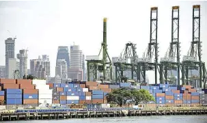  ??  ?? Essential for survival: Shipping containers stacked along the docking bay at the port in Singapore. The port has helped to put the republic on the world map by connecting it to far-flung, major centres of economic activity. — AFP