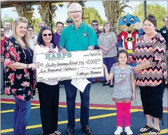  ?? Photo by Randy Moll ?? Jessica Summers, PTO president, Gayla Wilmoth, elementary school principal, Trinity Jacks, elementary school student, and Linda Johnson, high school office aide and great-grandmothe­r to Trinity, receive a $2,000 check for the Gentry Primary School PTO...