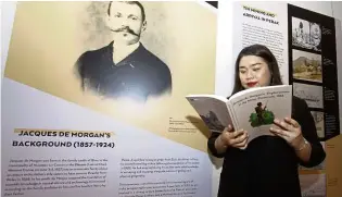  ?? — Bernama ?? A visitor reading Jacques de Morgan’s book at the exhibition launch.