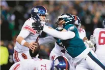  ?? ?? Philadelph­ia Eagles linebacker Haason Reddick, right, applies pressure on New York Giants quarterbac­k Daniel Jones during the first half.