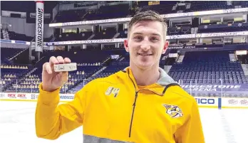  ??  ?? Former Moose Jaw Warriors forward Tanner Jeannot with the puck from his first NHL goal. (Nashville Predators photo)