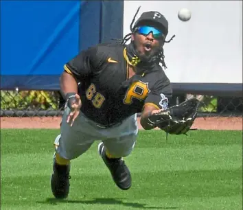  ?? Matt Freed/Post-Gazette ?? OUGHT-OH! Left fielder Troy Stokes Jr. dives for a ball hit by Tampa Bay’s Austin Meadows Wednesday in a game in Port Charlotte, Fla. The Pirates lost to the Rays, 3-1.