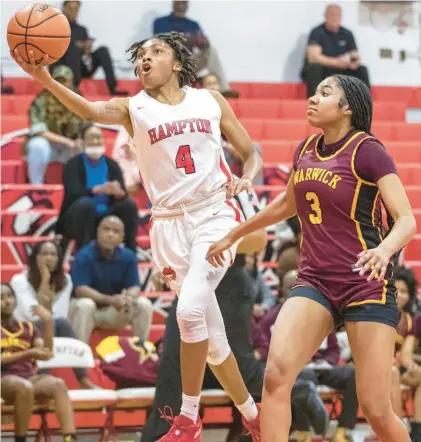  ?? MIKE CAUDILL/FREELANCE ?? Hampton’s Kennedy Harris goes up for a shot against Warwick’s Dejah Nunn during a Class 4 Region A Tournament quarterfin­al Tuesday night in Hampton. Harris finished with 35 points and took a 31.4 scoring average into the postseason, which is tied for best in the region.