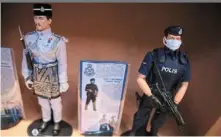  ?? ?? two figurines from the artist’s royal Malaysian Police series.