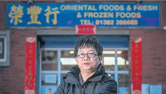  ?? Picture: Mhairi Edwards. ?? Owner of the Wing Fung shop Brian Chen outside the store yesterday.