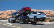  ?? DAVID PAUL MORRIS / BLOOMBERG ?? Tesla vehicles are transporte­d on a truck after leaving the company’s manufactur­ing facility in Fremont, Calif., last month.