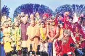  ??  ?? Governor Ram Naik and CM Yogi Adityanath with artists performing at a function on completion of one year of BJP government.