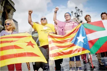  ??  ?? Protesters carry Esteladas, Catalan separatist flags, and Basque flags, during a rally in favour of a referendum on independen­ce from Spain for the autonomous community of Catalonia, in the Basque city of Bilbao, Spain. — Reuters photo